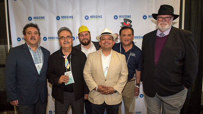 A group of Housing California members and board members smile at the camera during the Annual Conference. 