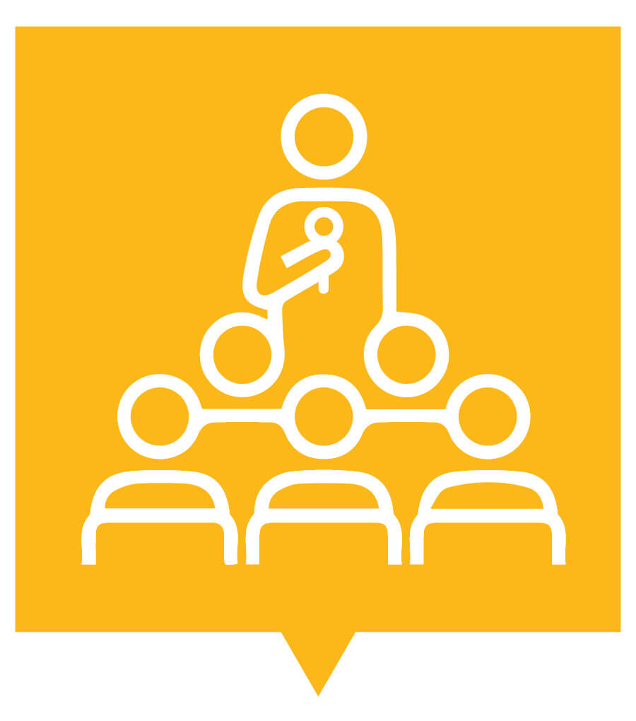 Computer-illustrated graphic. The background is a golden-yellow color. The graphic is an outline in white of a person holding a microphone and talking to an seated audience.